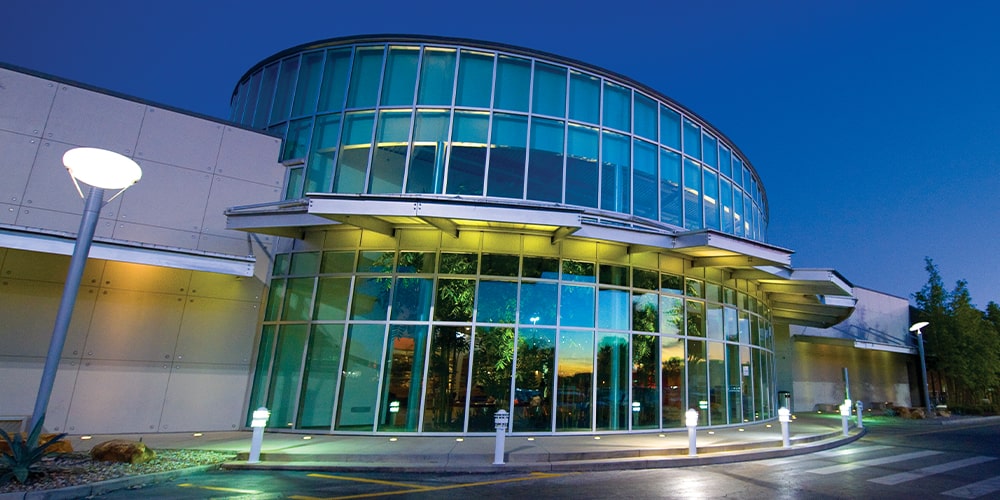 The front of Full Sail EB3 with glass windows at dusk.