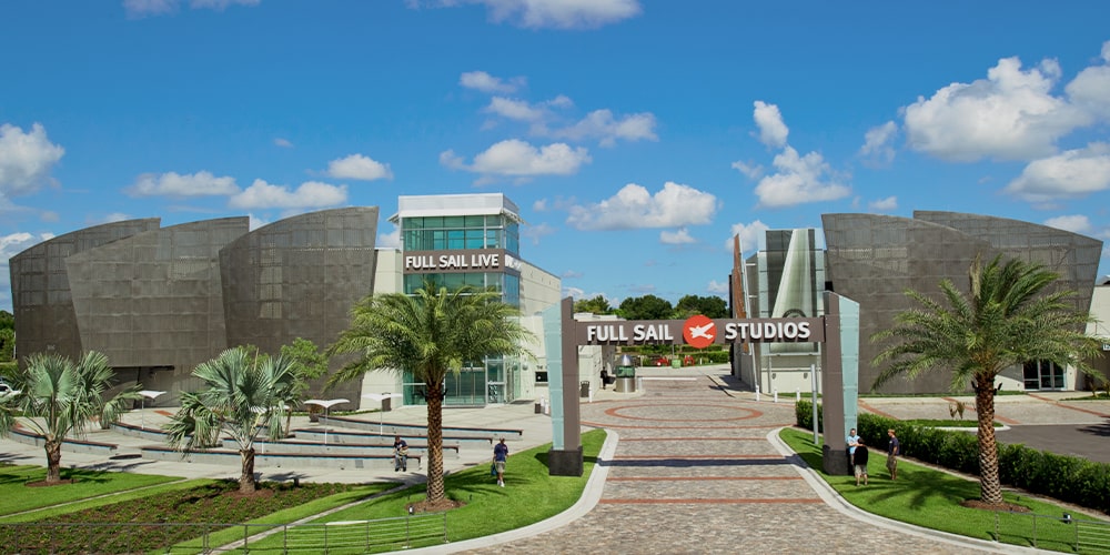 A daylight photograph of Full Sail Studios archway and the campus behind it.