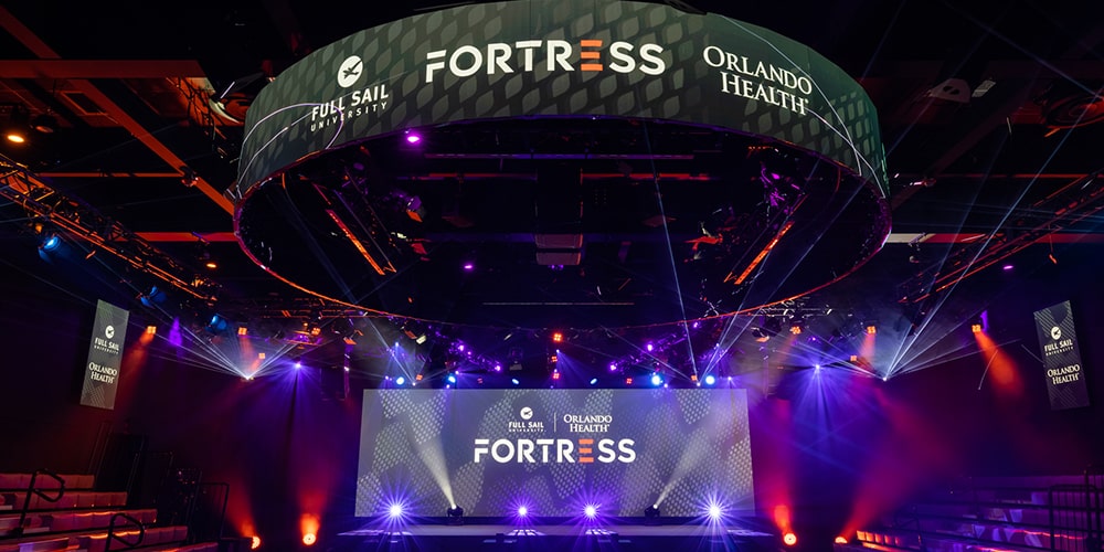 The Fortress screens with Full Sail University Orlando Health Fortress arena branding on it.
